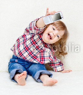 beautiful_little_child_holds_a_cell_phone.jpg